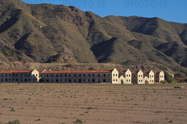 Settlement for workers of a mine in front of bare mountains