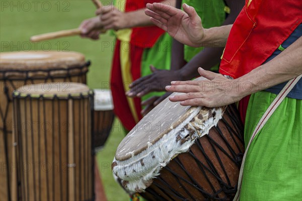 Musicians playing on an African djembe