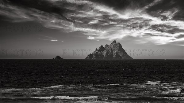 Two rocky islands in the sea at sunset