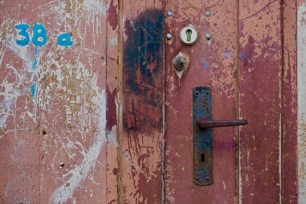 Rusty door handle on painted door