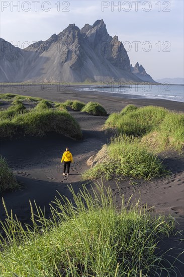 Young woman with rain jacket hiking