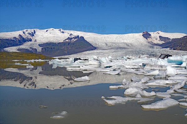 Icebergs and ice reflected in a lake