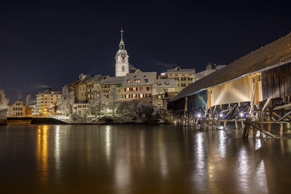 Old town and wooden bridge over the Aare in snow