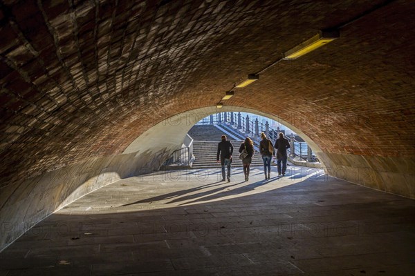 Passers-by cross a subway at the Schlossbruecke in Berlin-Mitte