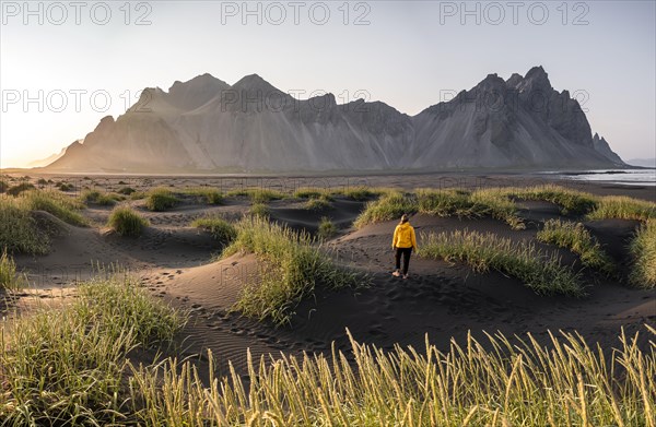 Young woman with rain jacket hiking