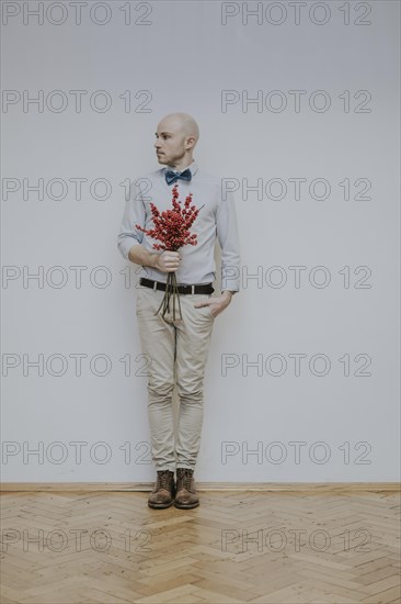 Man with bouquet of rose hips