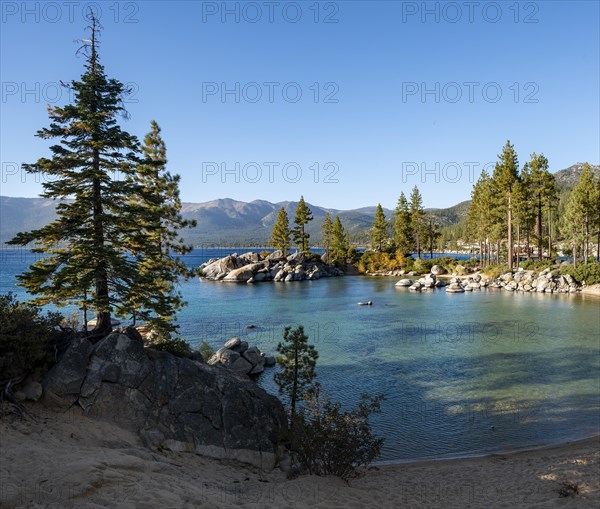 Sand beach and round stones in the water