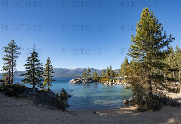 Sand beach and round stones in the water