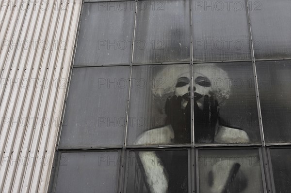 Industrial window with Marilyn Monroe behind the panes