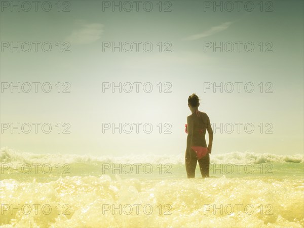 Woman bathing in the sea on the beach
