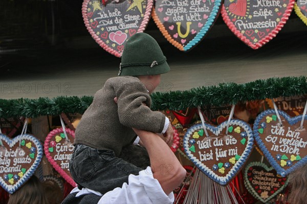 Man in front of stand with sugar hearts