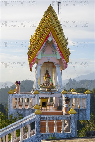 small golden pagoda on the temple hill in the evening