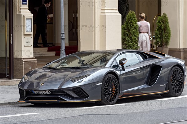 Parked Lamborghini Aventador sports car in front of Hotel Vier Jahreszeiten Kempinski