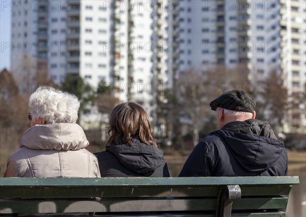 Seniors sitting on a park bench at the Segeluchbecken in the Maerkisches Viertel