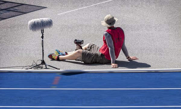 Photographer with red waistcoat during an athletics event at the Olympiastadion