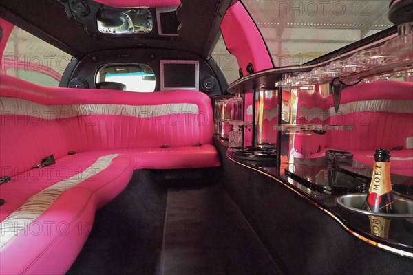 Luxury interior of a stretch limousine with pink upholstery