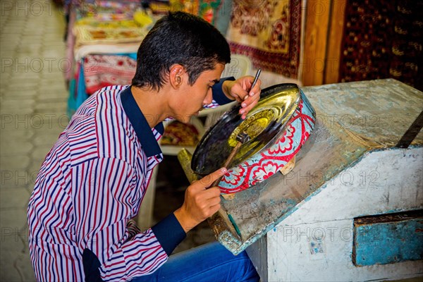 Boy driving metal bowl