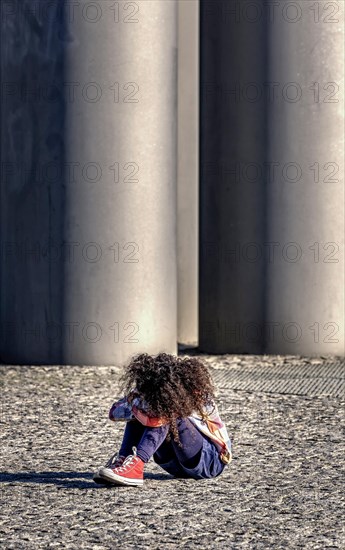 Toddlers sitting sadly on the floor