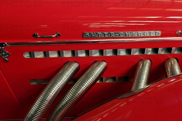 Cylinder hoses of a red Auburn Speedster
