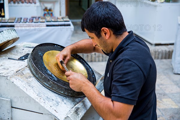 Man driving metal bowl