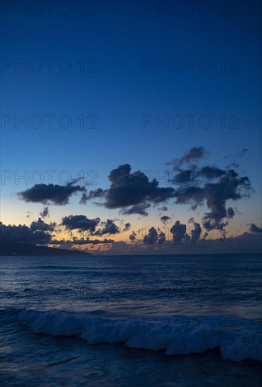 Sunset with clouds on the beach of Praia de Santa Barbara