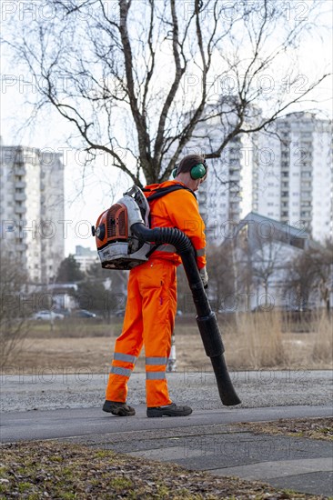 Employees of the horticultural office at work with the leaf blower