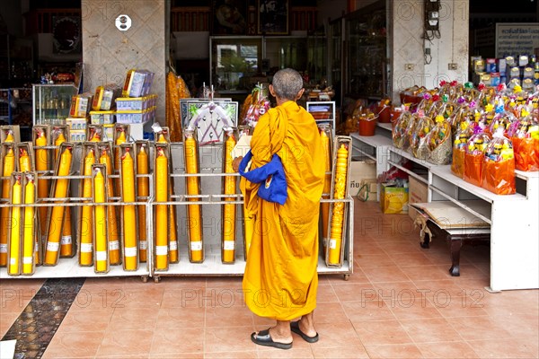 Monk in front of shop with temple requirements