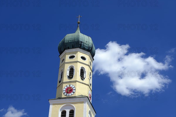 Onion dome of an Upper Bavarian church against a white blue sky