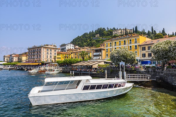 Ferry boat anchored in front of the promenade of Bellagio on Lake Como