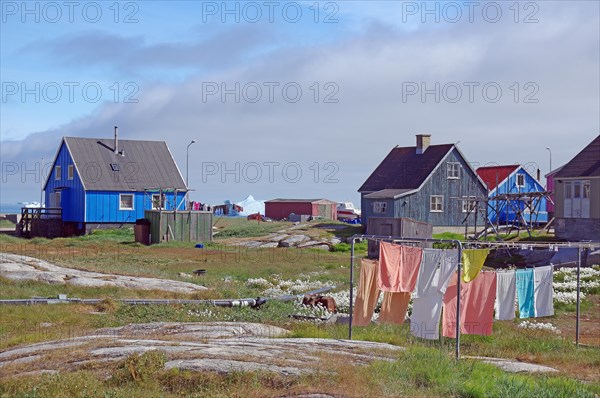 Laundry hanging in front of simple wooden houses