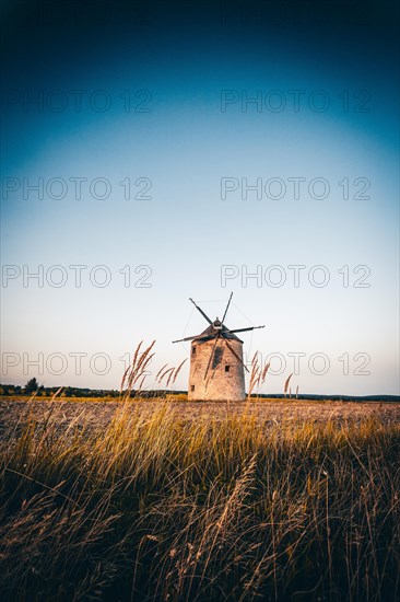 The Old Windmill of Tes in the sunset with guests