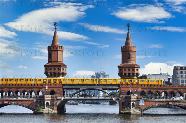 Yellow S-Bahn on Oberbaum bridge over the Spree river