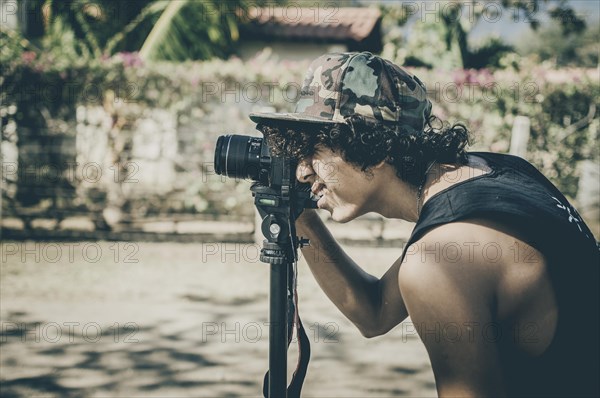 Young man taking a photo on the beach