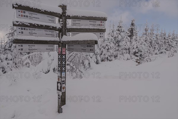 Signpost in winter on the Kahler Asten in Sauerland