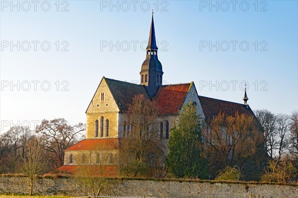 Church with old wall in the glow of the winter sun