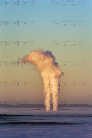 Two columns of steam rising from cloud cover