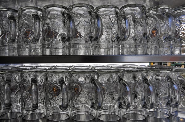 Beer mugs turned upside down on shelf