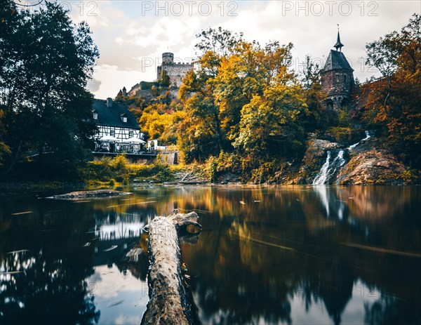 Pyrmonter mill at the waterfall of Elzbach with the castle Pyrmont in the back