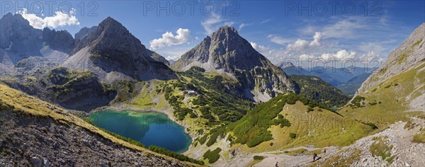 Mountain panorama above the Drachensee and the Coburger Huette with the mountain peaks of the Sonnenspitze