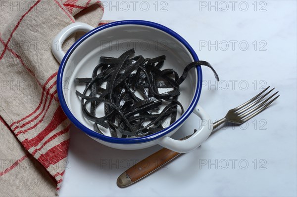 Black pasta with squid ink in bowl