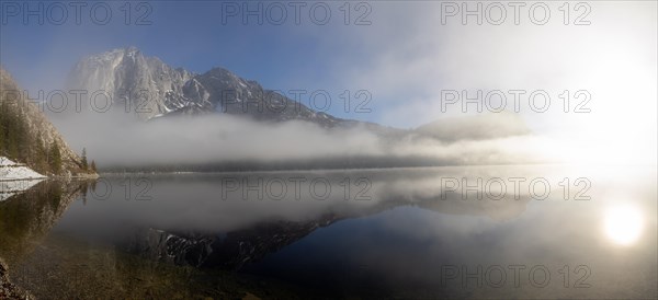 Fog clears in front of the Trisselwand at Lake Altaussee