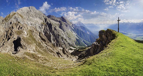 Summit cross of the Wankspitze with view into the Inn valley and the Mieminger Gebirge