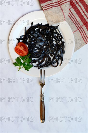 Black pasta with squid ink on plate