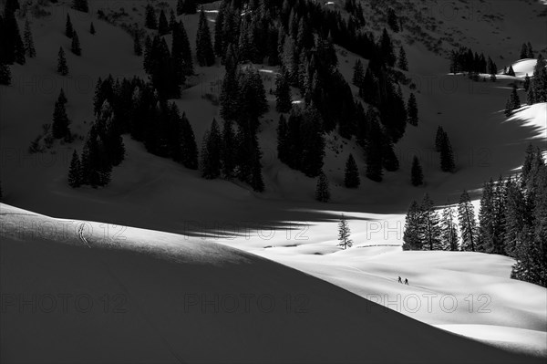 Two ski tourers in wintry mountain landscape