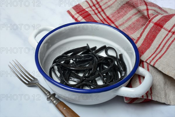 Black pasta with squid ink in bowl
