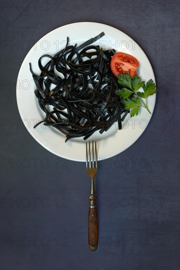 Black pasta with squid ink on plate