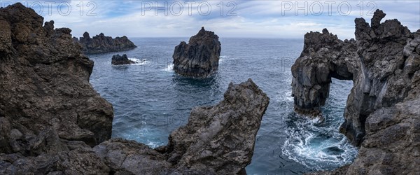 Rocky lava coast with rock gate