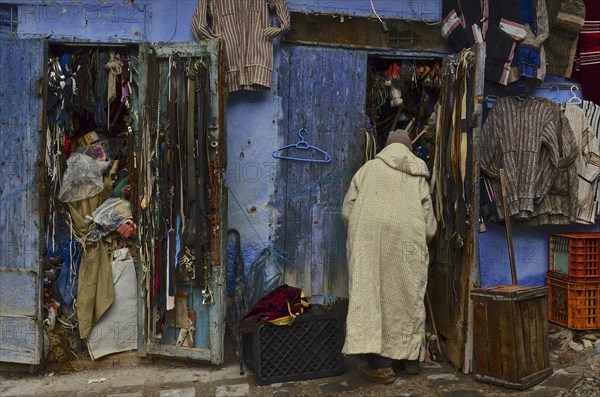 Man ivoor his shop in the medina with belts