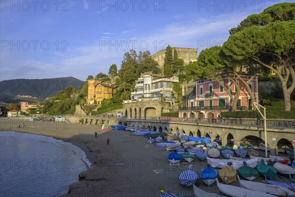 Covered fishing boats and the town beach