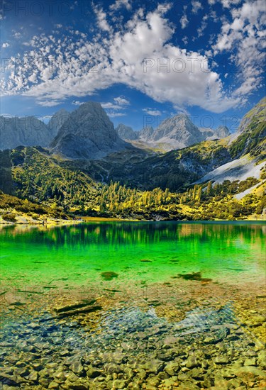 Turquoise Lake Seebensee and the mountain peak of the Tajakopf under a bizarre cloudy sky